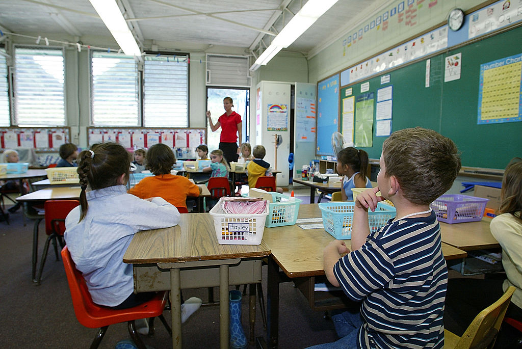 Hawaiian children taking instruction from teacher