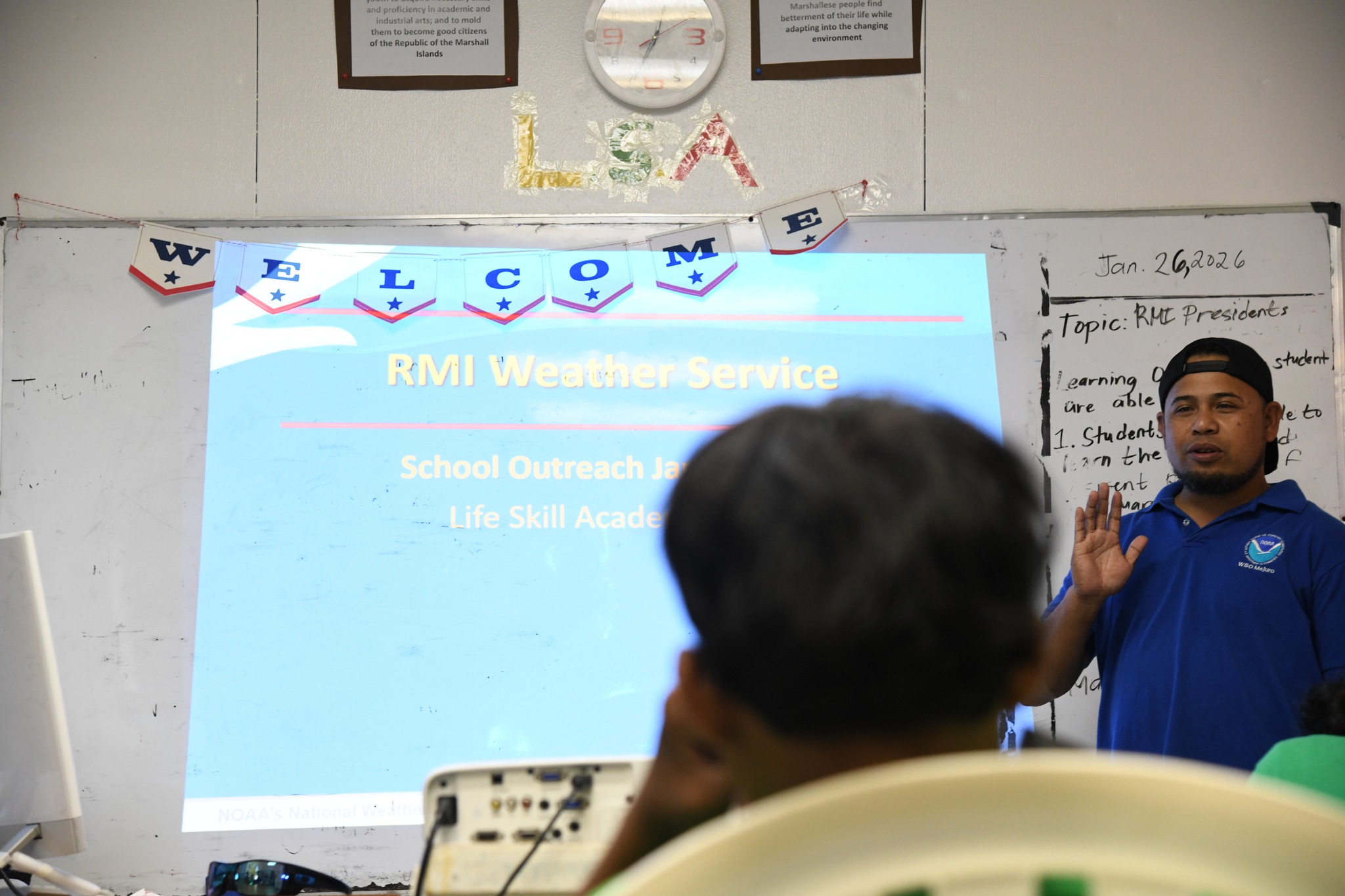 Image of teacher and a chalkboard