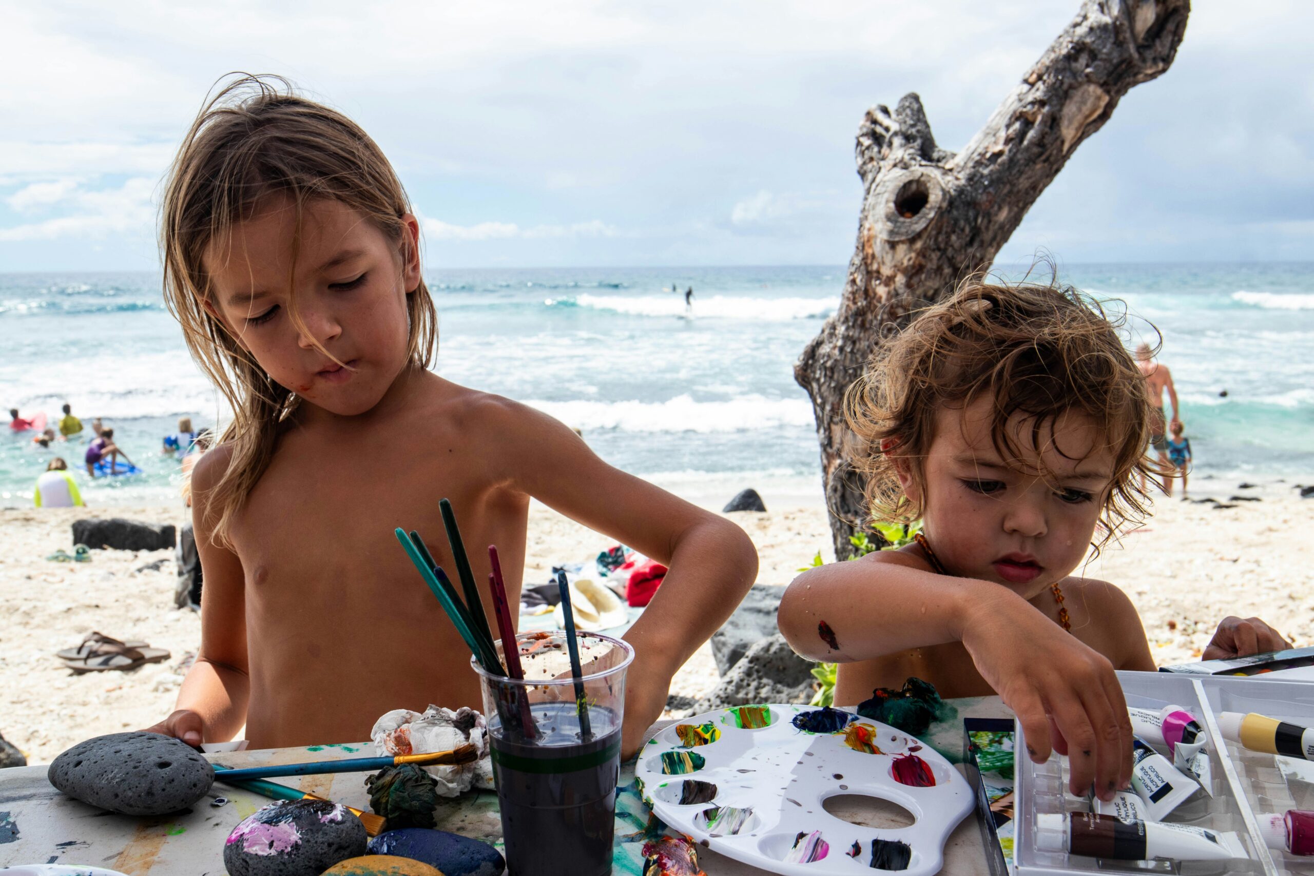 kids play with paints on the beach